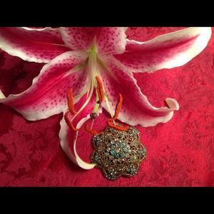 Brooch/pendant with green accent rhinestones.