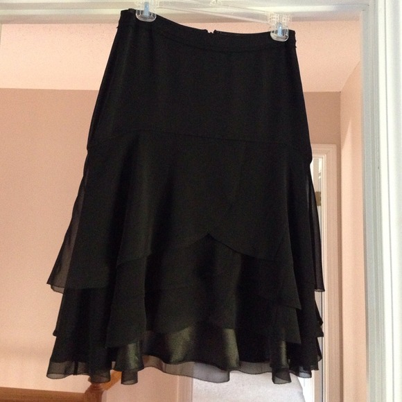 Black layered flutter skirt, short but not mini.