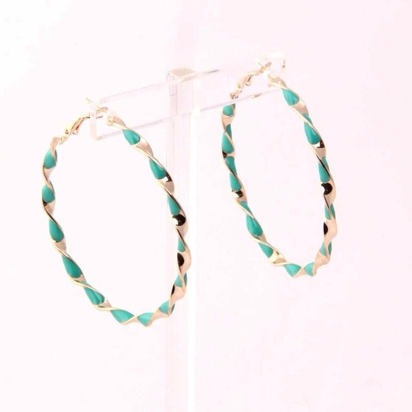 Sea green and gold colored hoop earrings.