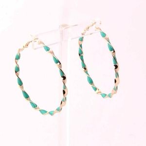 Sea green and gold colored hoop earrings.
