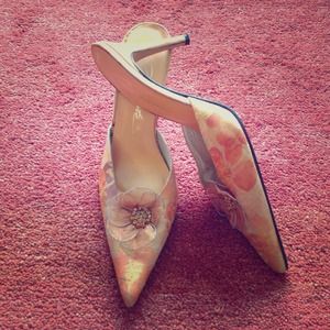 Orange floral heels with flower adornment at toe.