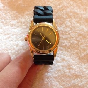 Black and gold watch with rubber link band