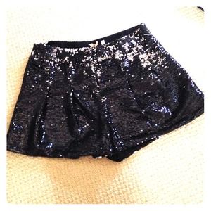 Sparkly spangled black shorts.