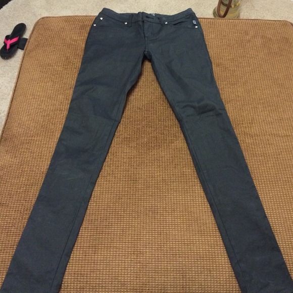 Pants - Black coated skinny jeans.