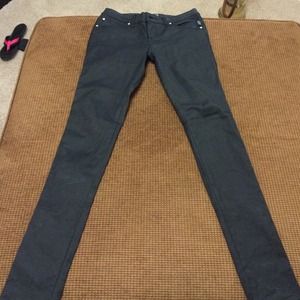 Black coated skinny jeans.