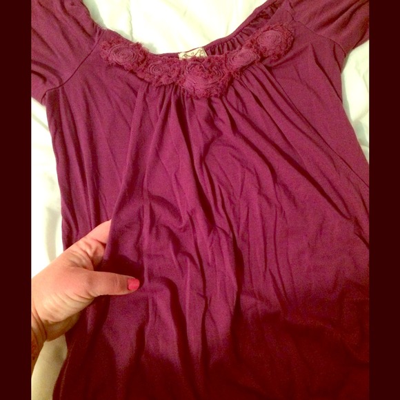 Purple top with rosettes and pocket