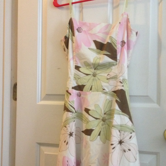 Adorable floral dress with pink and green accents.