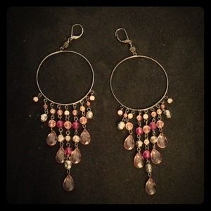 long pink dangling hoop earrings.