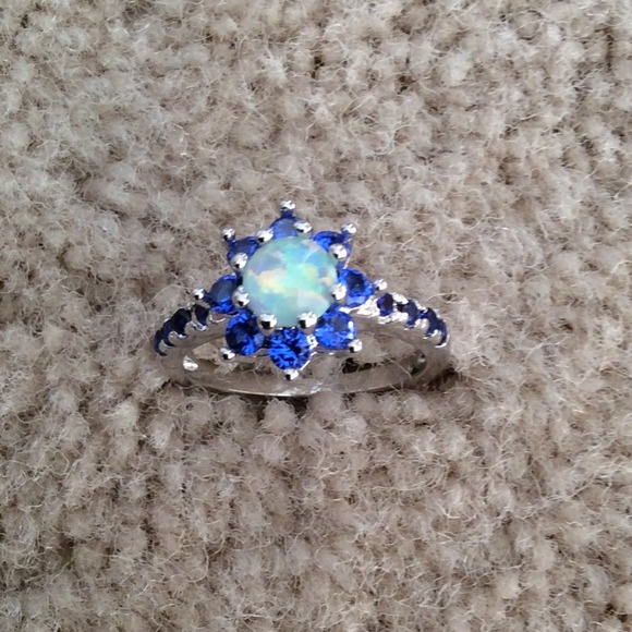 Flower ring with blue topaz and white fire opal