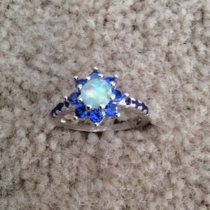 Flower ring with blue topaz and white fire opal