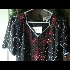 Black sequins. Dress with red flowers. Sequin.