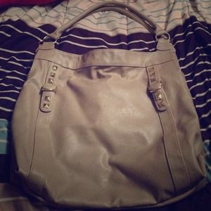 Cream colored purse with gold studs