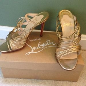 Gold strappy Louboutin heeled sandals
