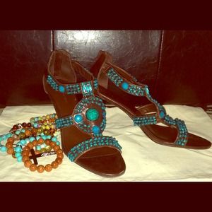 Chocolate bejeweled leather sandal.