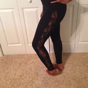 Black leggings with lace panels on the sides.