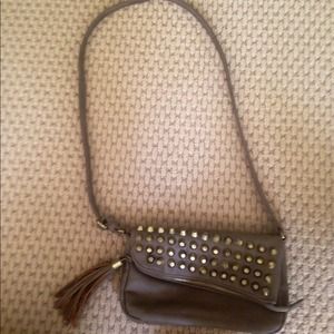Taupe purse with gold studs and tassel zipper