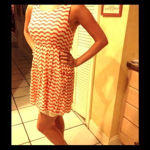 Orange and cream striped sleeveless sundress.