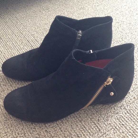 Black suede ankle boots with gold zipper detail
