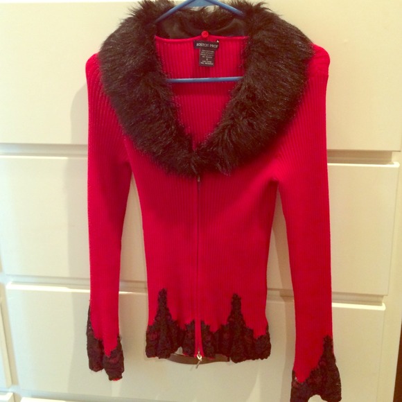 Red sweater with faux black fur collar.