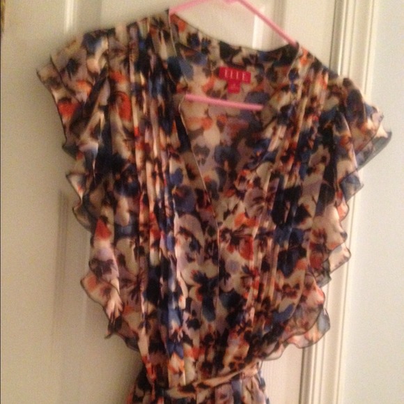 Sheer button blouse comes with a navy blue cami