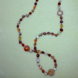 Handcrafted necklace made of various round stones.