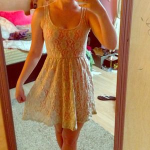 Flirty beige lace dress with orange underneath