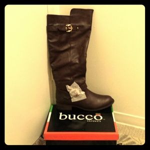 Dark brown riding boots with gold buckles