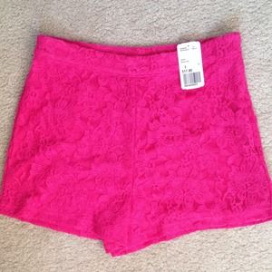 High waisted, hot pink shorts.