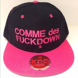 new black and pink "comme des fuckdown" snapbacks