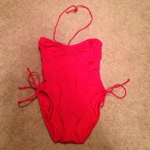 Red one piece bathing suit with side cut outs