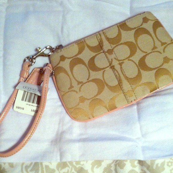 Coach wristlet with pink leather accents