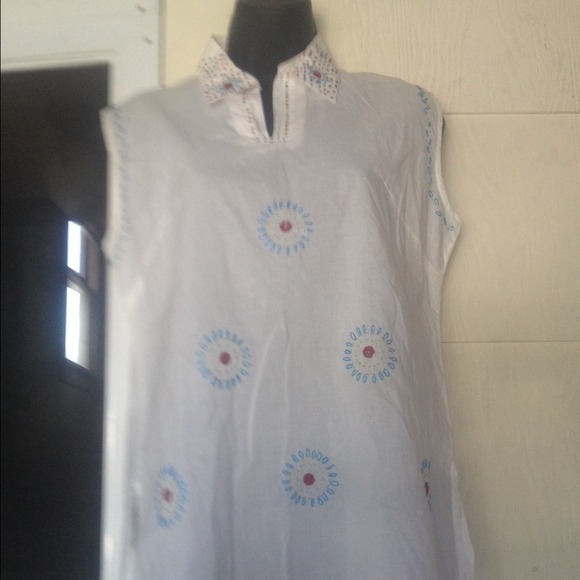 White top with embroidery embellishments.