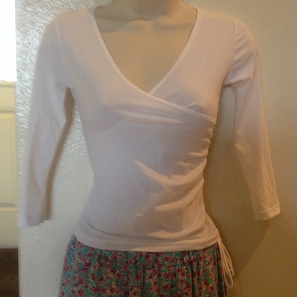 White v-neck top.