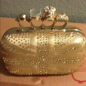 Gold knuckle clutch bag