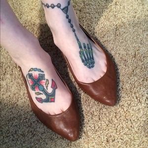 Brown pointy toe flats with gold tiny spikes.