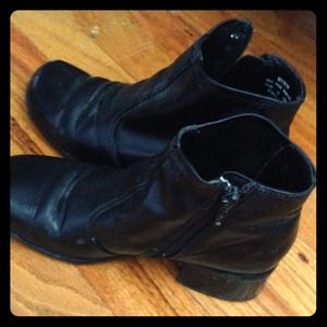 Black leather zip up boots.