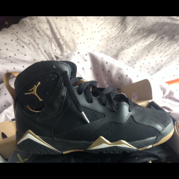Jordan size 6 , black gold & white .