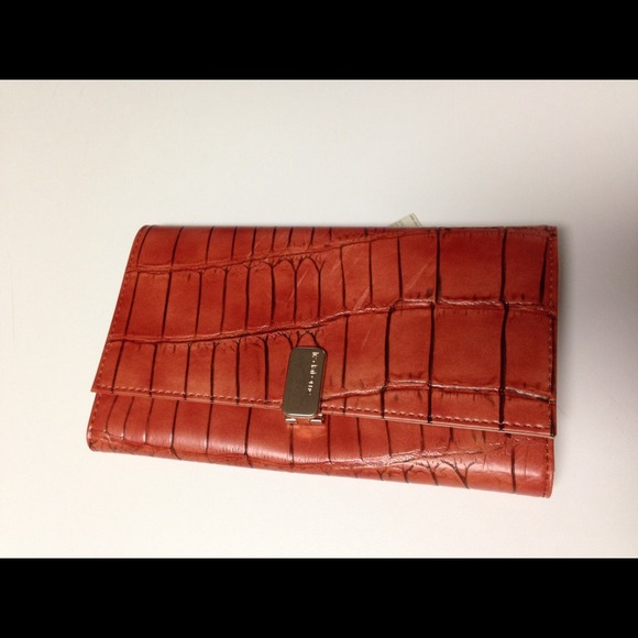 Liz Claiborne Persimmon colored tri fold wallet.