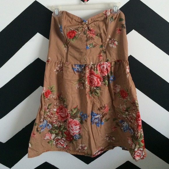 Brown strapless dress with flower detail.