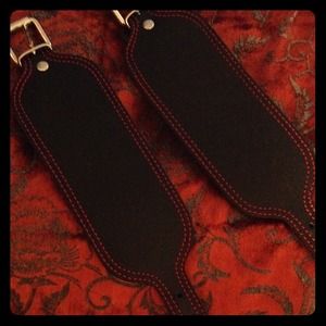 2 black bracelet cuffs with red stitching
