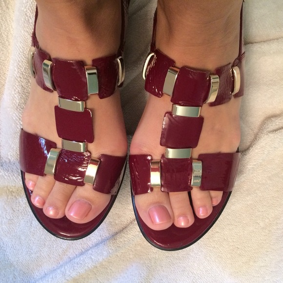 Red sandals with gold embellishments.