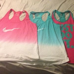 Three Nike athletic tank tops.
