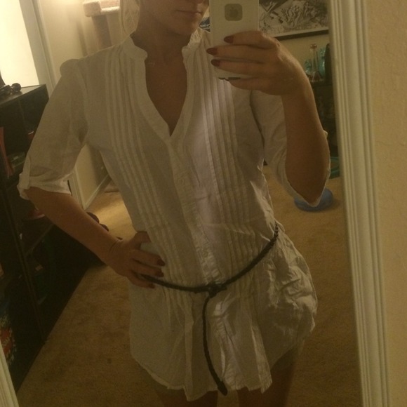 Long, white blouse with pleats down the front.