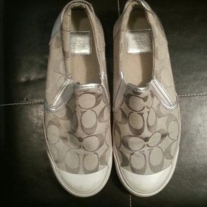 Silver slip on Coach shoes.