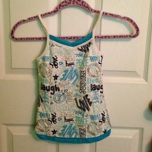 A blue tanktop with wording and peace signs