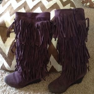 A pair of purple fringe boots.