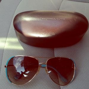 Teal rimmed Michael Kors Aviator style sunglasses.