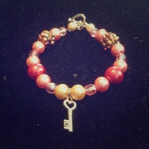 ON HOLD Pink bracelet with key charm. NWT