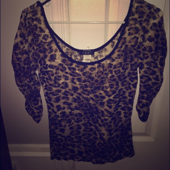 Leopard print shirt hangs over shoulders a little