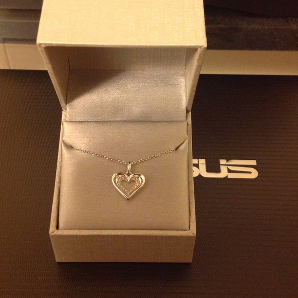 Zales silver heart within pendant. With diamonds.